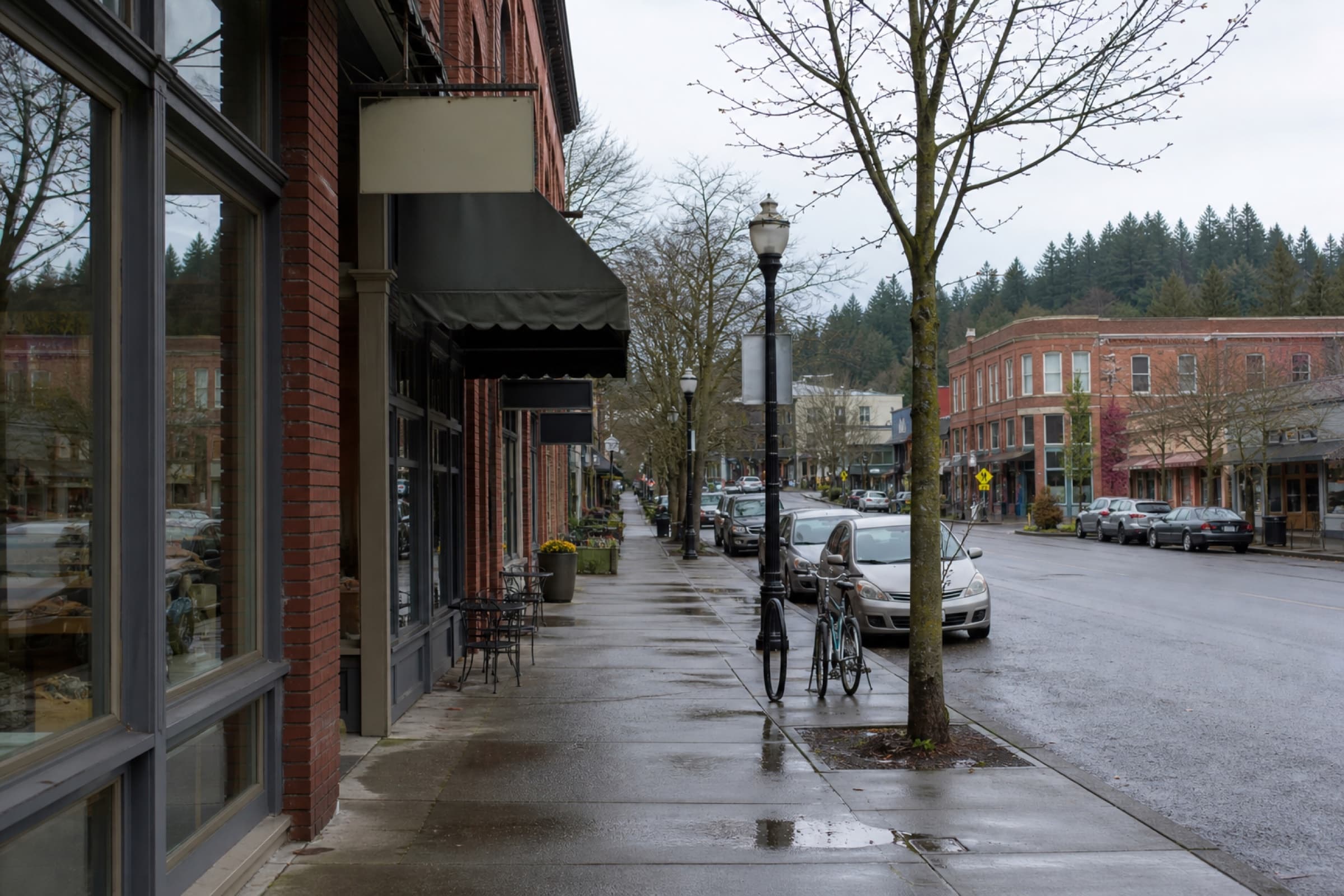 Brick storefronts on a rainy downtown street in a small Pacific Northwest city